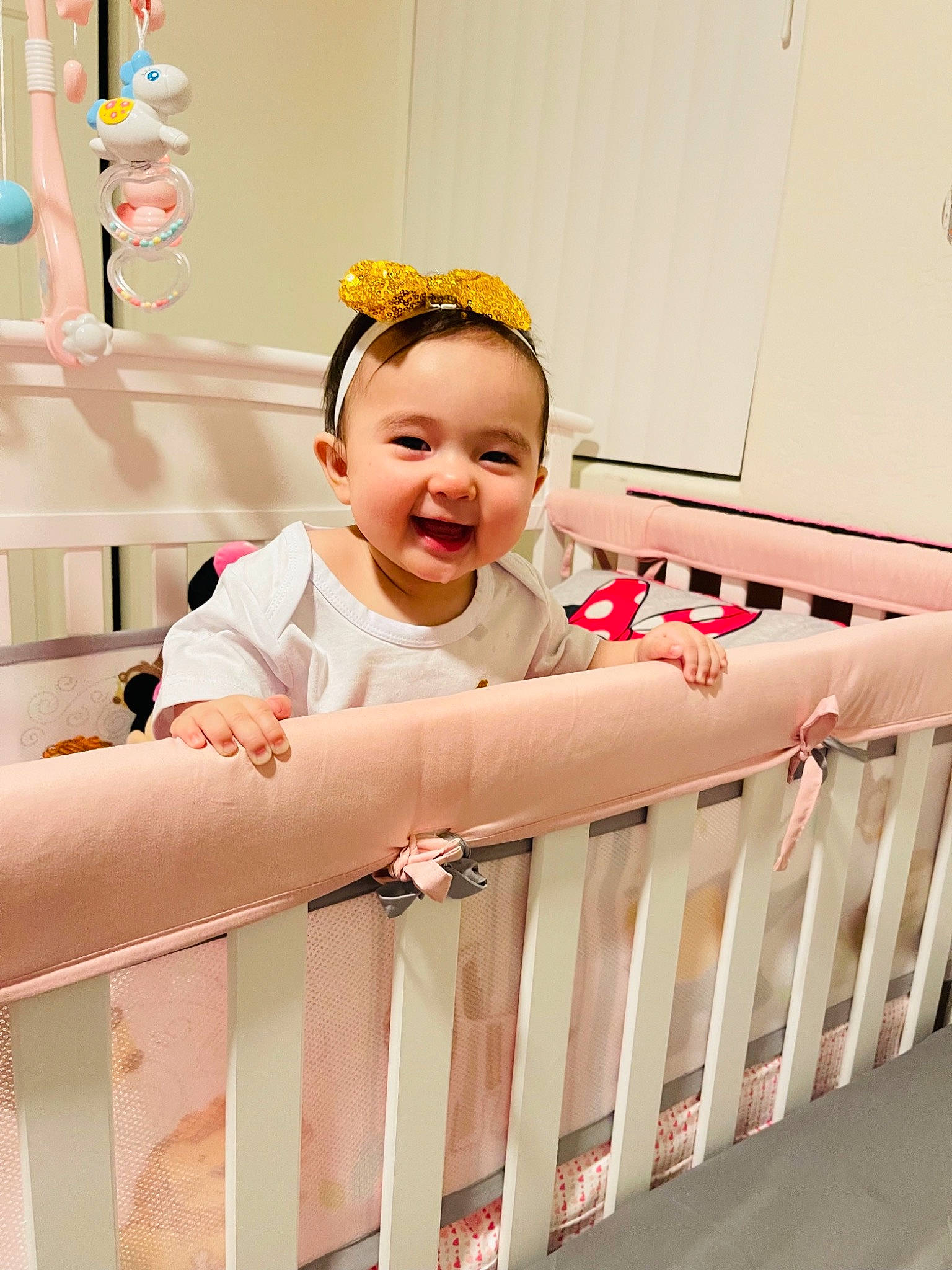 Kylie is registered to the contest to win money with this photo: baby, baby_products, baby_safety, baby_toddler_clothing, baby_toys, child, cradle, facial_expression, fun, happy, headband, infant_bed, linens, nursery, person, pink, room, skin, sleeve, smile
