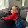 Alba a rejoint le concours — aidez-le/la à gagner de superbes lots ! toddler, child, smile, red_shirt, denim_overalls, pigtails, couch, indoor, playful, happy, person, home, window, curtain, pillow, cozy, face, hair, furniture, casual_clothing