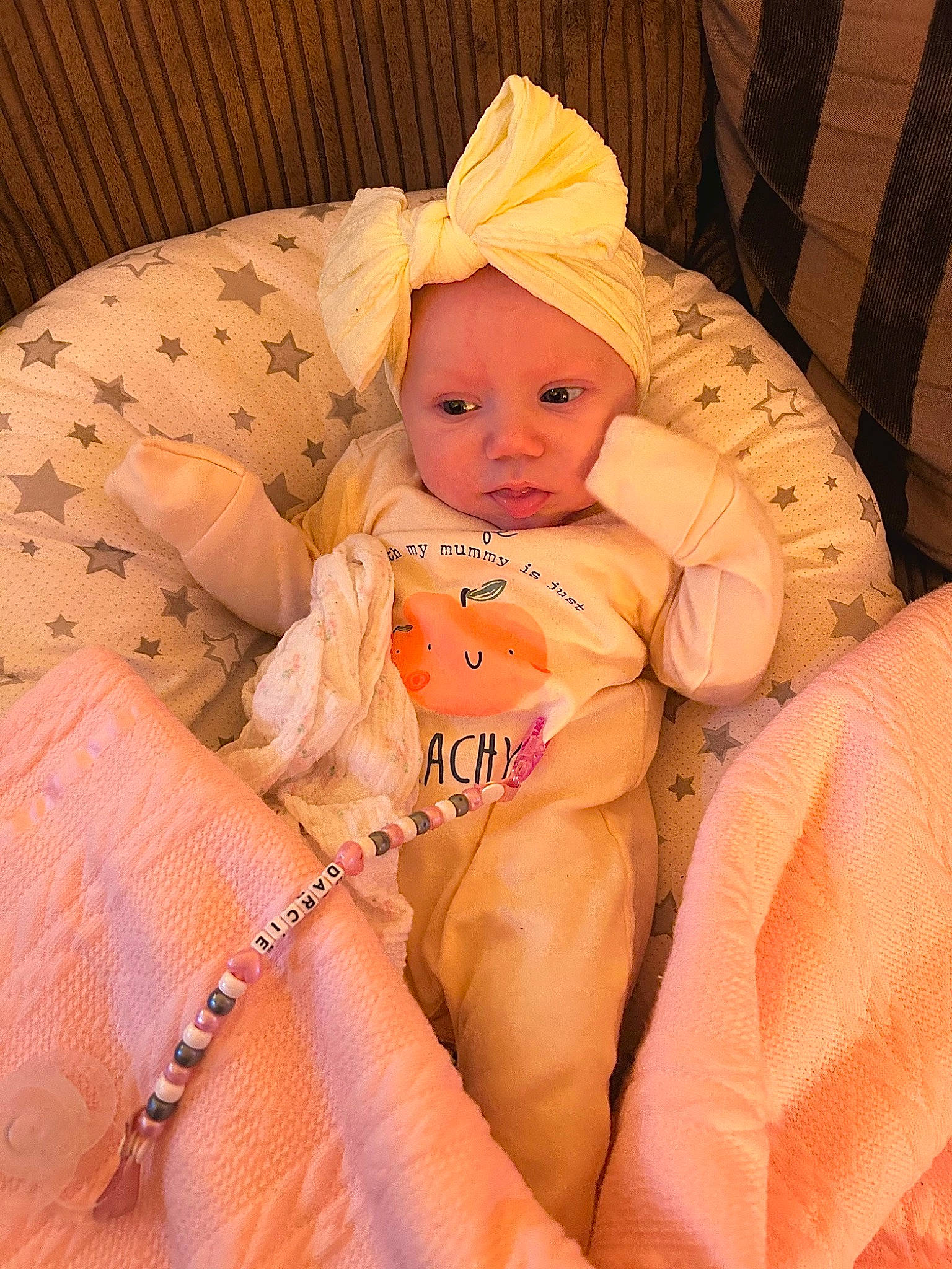 Darcie is registered to the contest to win money with this photo: abdomen, baby, baby_safety, baby_sleeping, baby_toddler_clothing, cheek, child, comfort, eye, face, headwear, human_body, iris, lap, linens, person, sitting, skin, textile, thigh