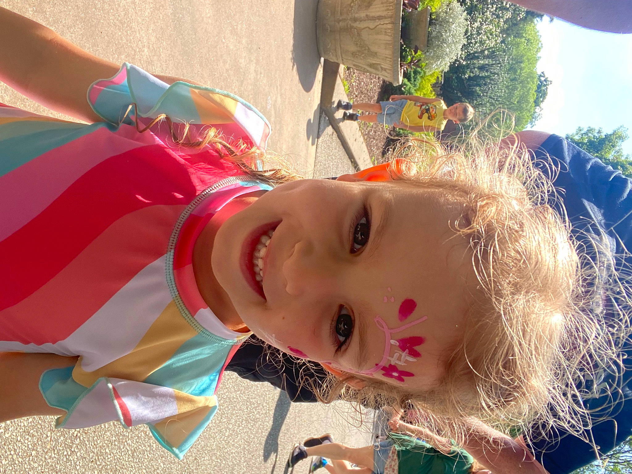 Amelia is registered to the contest to win money with this photo: child, eyelash, eyewear, fun, grass, happy, joy, leisure, light, lip, people_in_nature, person, pink, plant, recreation, sky, smile, spring, summer, sunlight