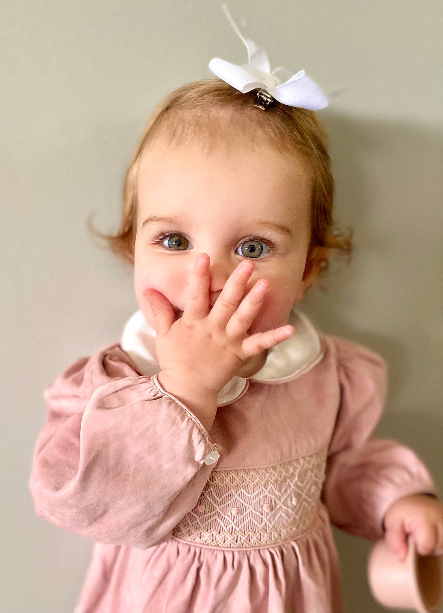 Sydney is registered to the contest to win money with this photo: arm, baby_toddler_clothing, cheek, chin, clothing, dress, ear, eye, eyebrow, eyelash, face, hand, head, iris, lip, neck, nose, person, skin, sleeve