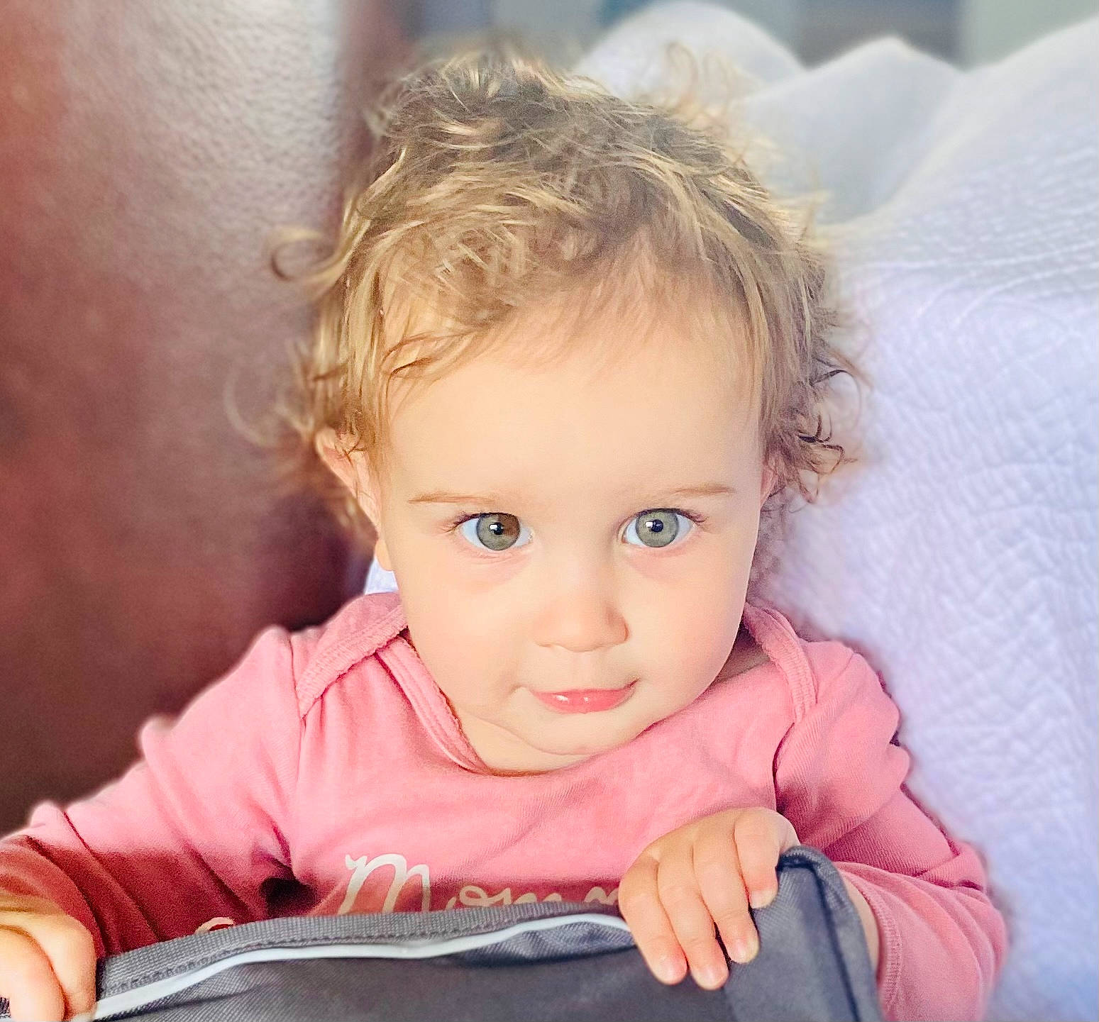 Sydney is registered to the contest to win money with this photo: arm, baby, baby_toddler_clothing, cheek, child, comfort, eyelash, facial_expression, finger, gesture, hair, hand, happy, iris, lip, nose, person, skin, sleeve, smile