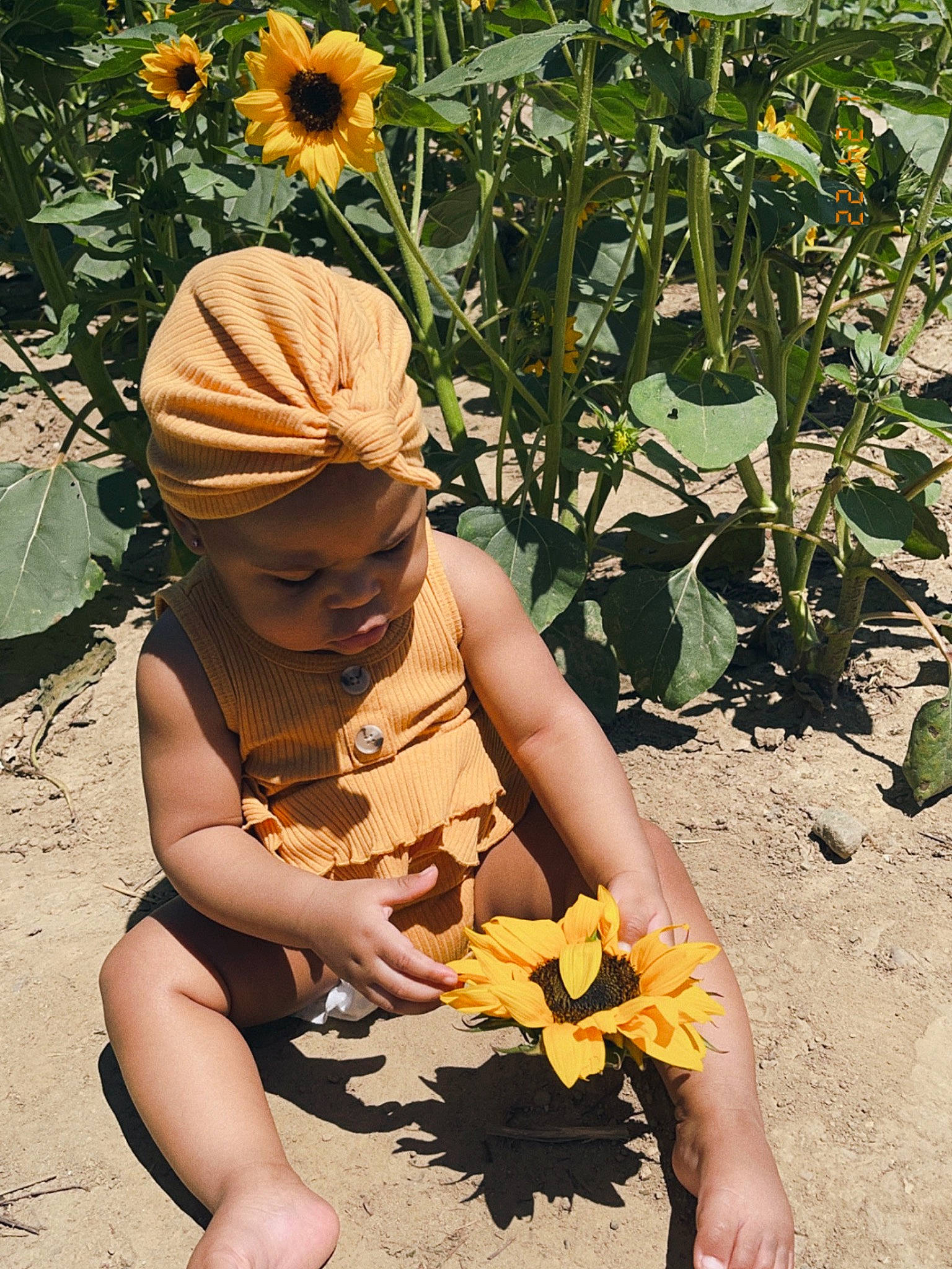 Siann joined the competition — help win amazing prizes! adaptation, annual_plant, art, botany, dress, flower, flowering_plant, garden, grass, happy, hat, leaf, people_in_nature, person, petal, plant, sculpture, sitting, soil, spring