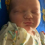 Waverly is registered to the contest to win money with this photo: baby, sleeping, onesie, animal_prints, blanket, blue, yellow, cartoon, face, peaceful, infant, closeup, soft_lighting, child, cute, resting, portrait, newborn, cozy, sleep