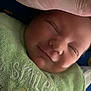 baby, sleeping, closeup, face, hand, towel, green, smile, newborn, infant, soft, peaceful, cute, child, skin, portrait, resting, indoors, fabric, warm