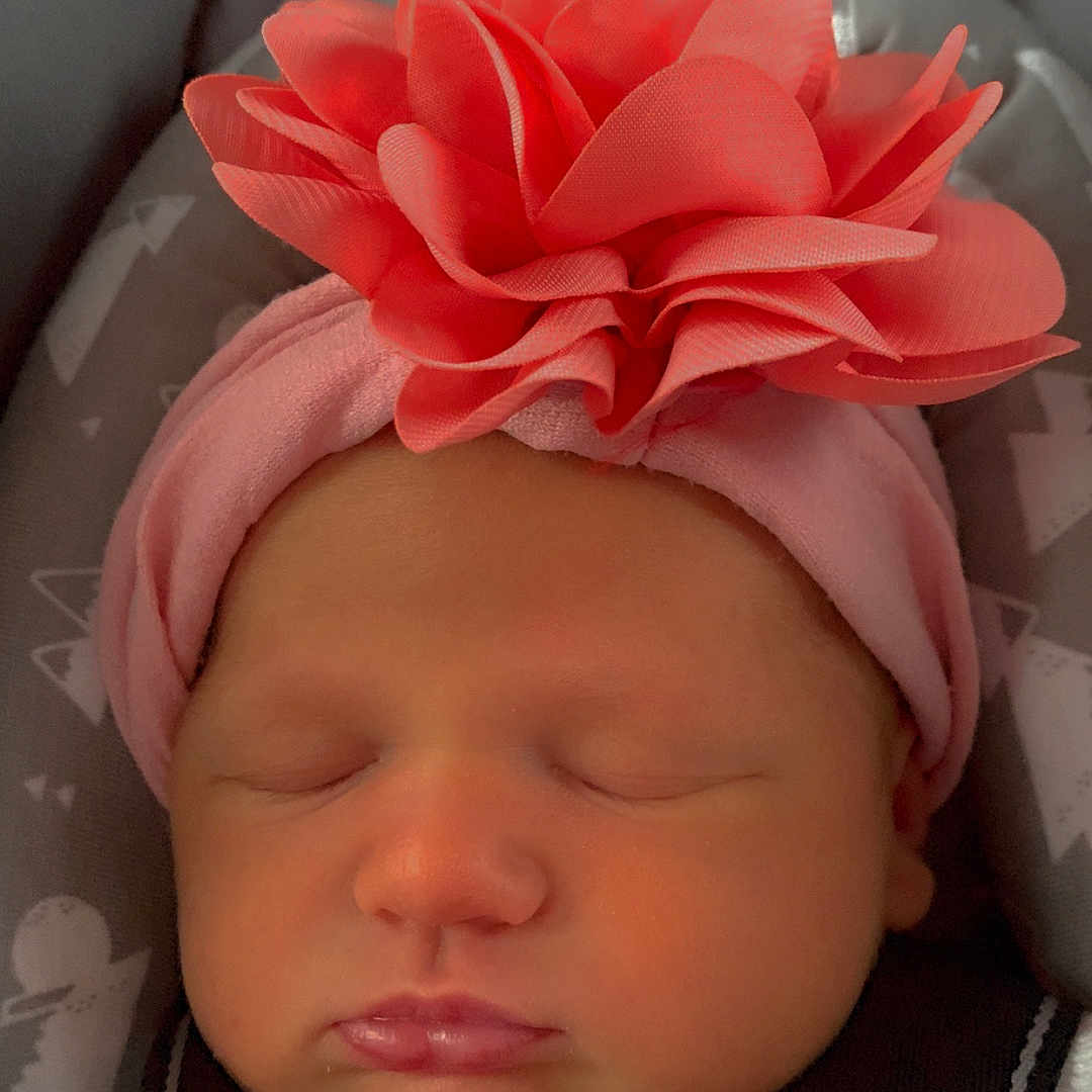 Waverly is registered to the contest to win money with this photo: baby, car_seat, child, closed_eyes, clothing, cute, fabric, face, flower, harness, headband, indoor, infant, newborn, pattern, peaceful, pink, portrait, sleeping, soft