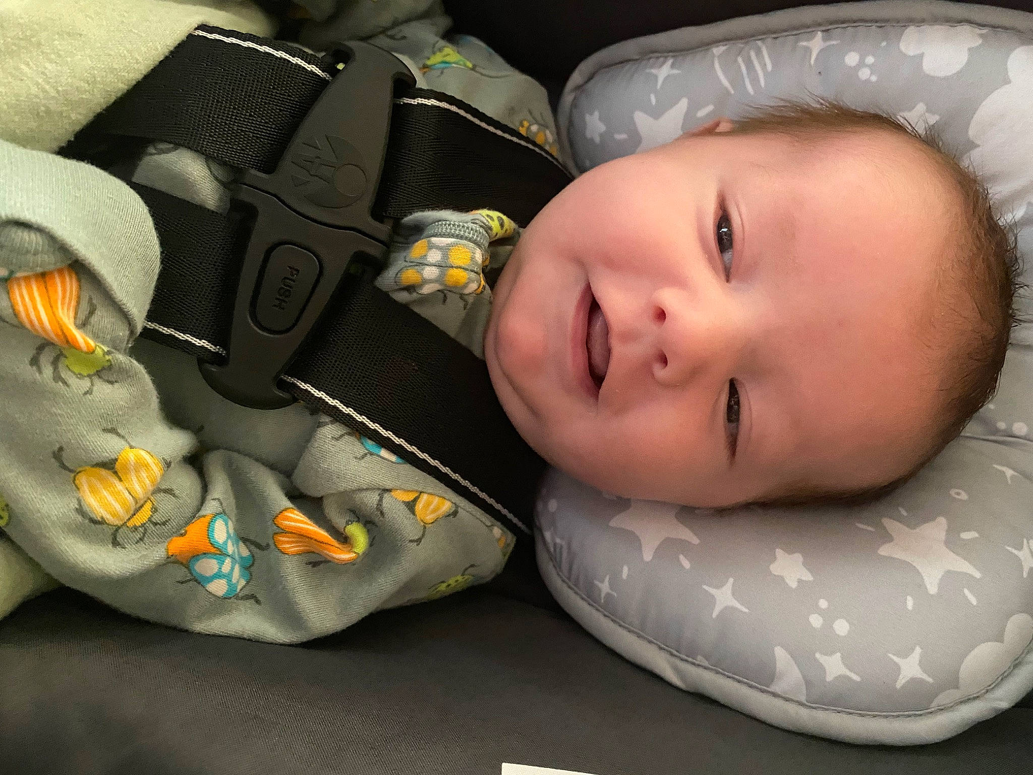 Cohen is registered to the contest to win money with this photo: auto_part, baby, baby_products, baby_safety, baby_toddler_clothing, car_seat, carmine, cheek, child, comfort, fashion_accessory, happy, outdoor_shoe, pattern, person, personal_protective_equipment, product, smile, toddler