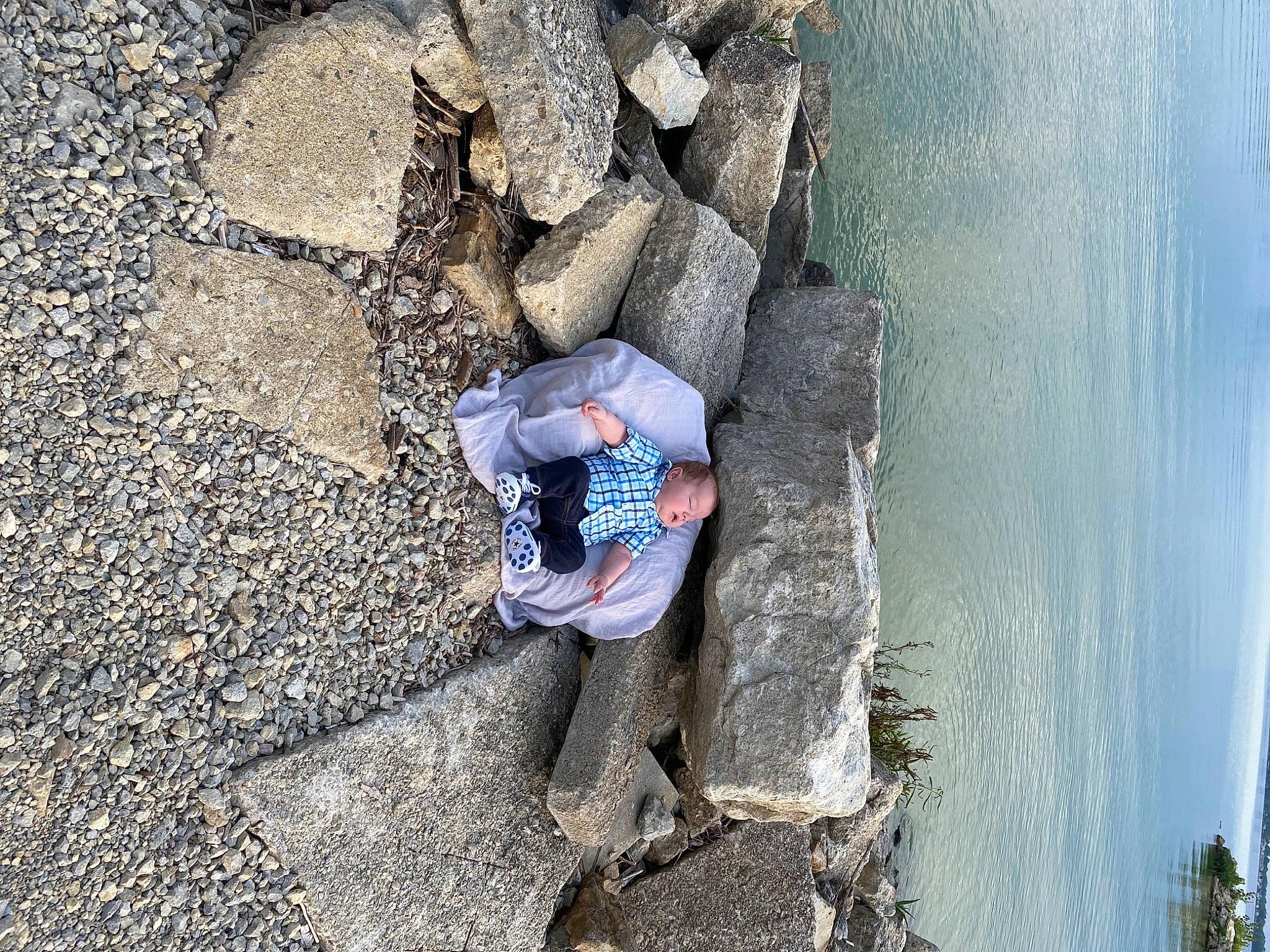 Cohen is registered to the contest to win money with this photo: adventure, beach, bedrock, coast, cobblestone, denim, fun, geological_phenomenon, geology, lake, leisure, person, plant, recreation, rock, sky, soil, tree, wall, water