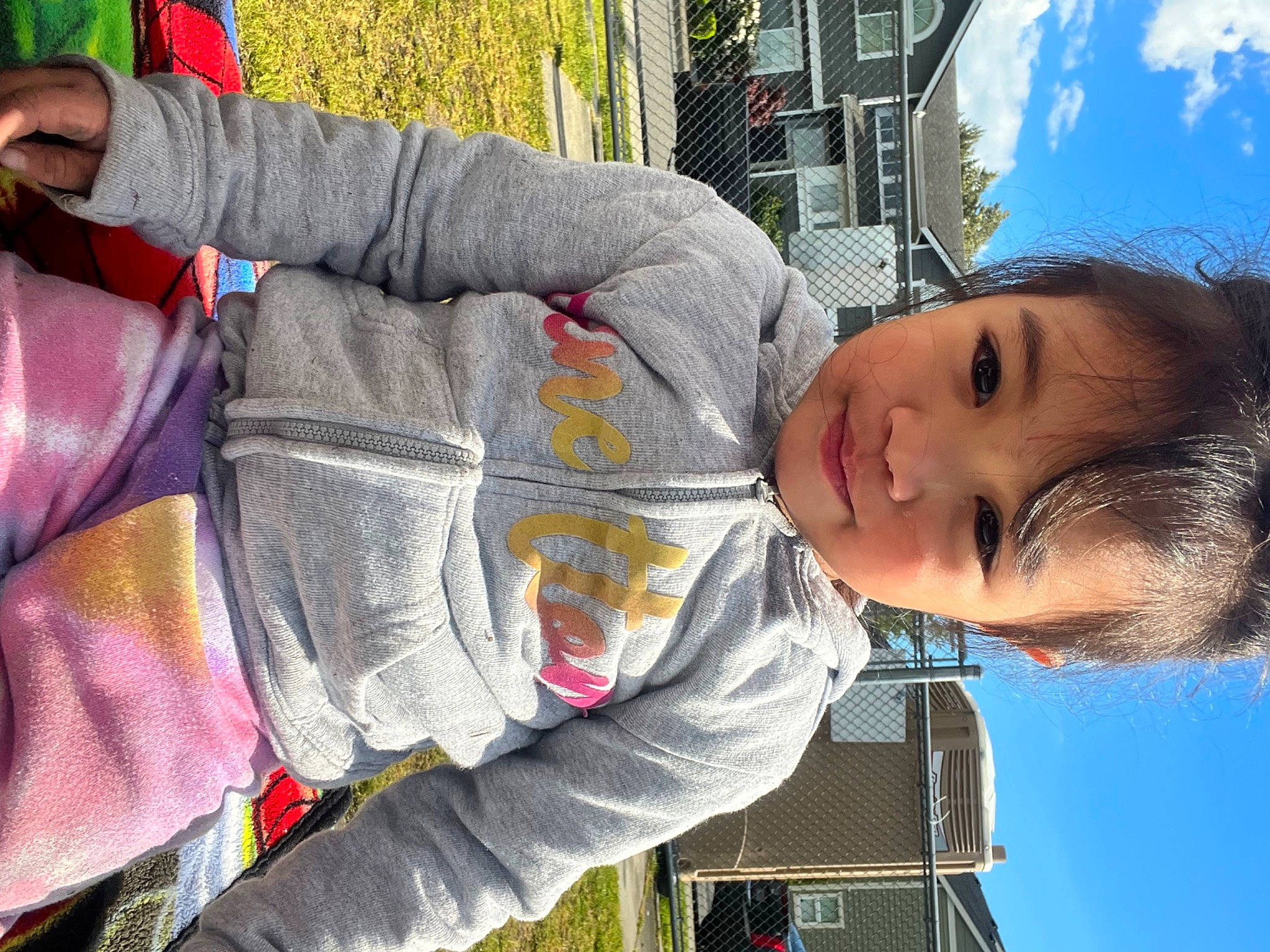 Maya is registered to the contest to win money with this photo: baby_products, child, cloud, facial_expression, fun, happy, human, leisure, organ, person, photograph, sitting, sky, smile, snapshot, toddler, travel, tree, vacation, white