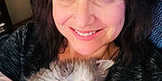 Nissan joined the competition — help win amazing prizes! woman, smiling, blue_eyes, tattoo, kitten, sleeping, fluffy, gray_cat, indoor, close_up, portrait, casual_clothing, holding_pet, happy, relaxed, cute, pet, human, face, hair