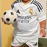 Issa a rejoint le concours — aidez-le/la à gagner de superbes lots ! ball, boy, child, clothing, face, football, footwear, head, male, person, photography, portrait, shirt, shoe, shorts, sitting, sneaker, soccer, soccerball, sport