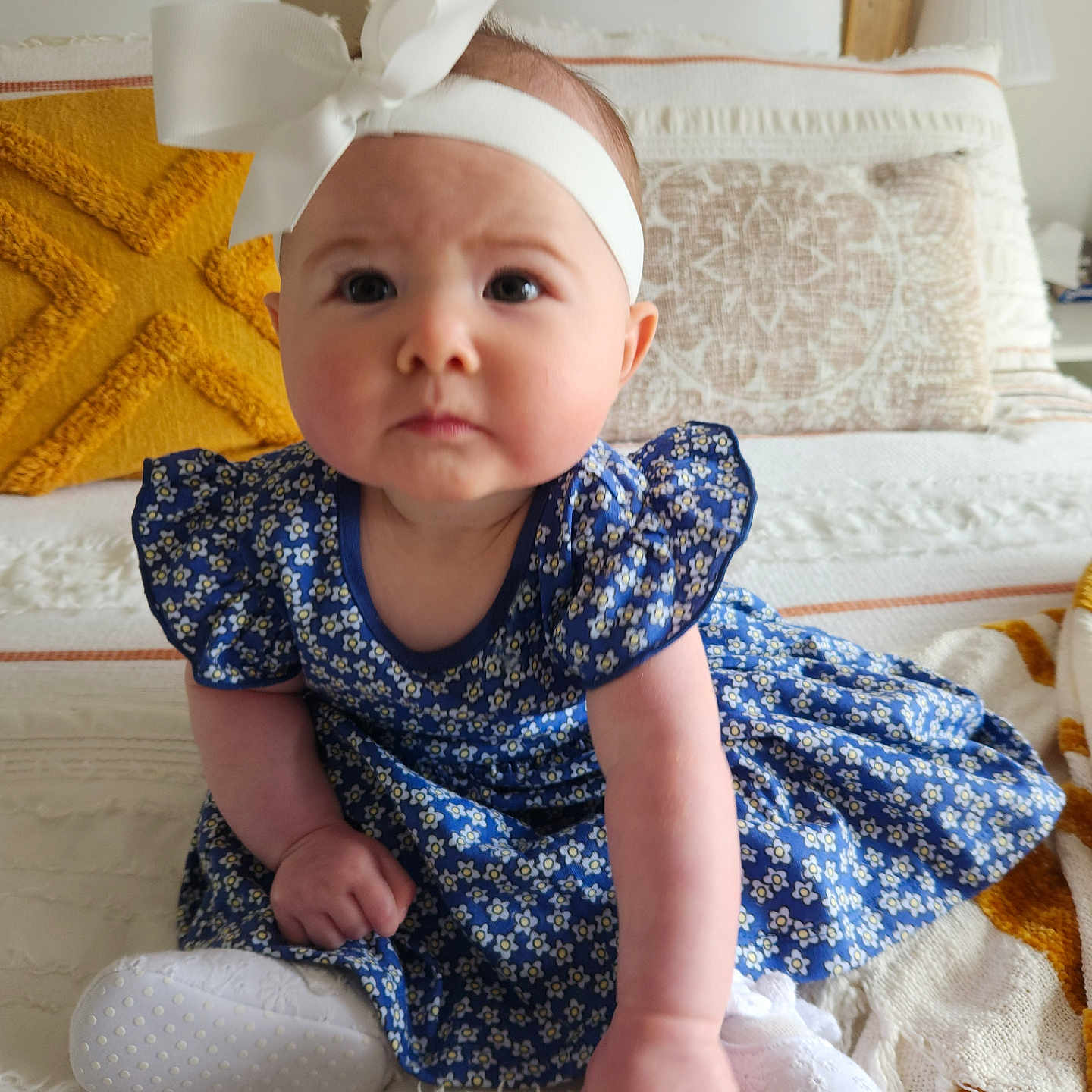 Mali is registered to the contest to win money with this photo: accessories, baby, bodypart, clothing, couch, cushion, dress, face, finger, footwear, furniture, hand, hat, head, homedecor, person, photography, portrait, shoe, sitting