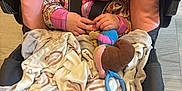 Emerson joined the competition — help win amazing prizes! baby, car_seat, pacifier, blanket, toy, sleeping, child, indoor, infant, clothing, plush_toy, comfort, peaceful, cute, hands, floor, fabric, seat_belt, toddler, rest