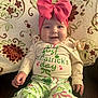 Emerson is registered to the contest to win money with this photo: baby, child, smiling, pink_bow, headband, st_patricks_day, green, clothing, patterned_pants, sitting, blanket, floral_pattern, cute, happy, indoors, portrait, face, hands, cozy, festive