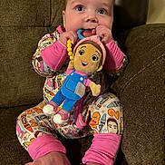 Emerson is registered to the contest to win money with this photo: baby, child, pajamas, plush_toy, couch, foot, hand, smile, face, sitting, indoors, toy, colorful, cute, comfort, happy, infant, person, soft_lighting, closeup