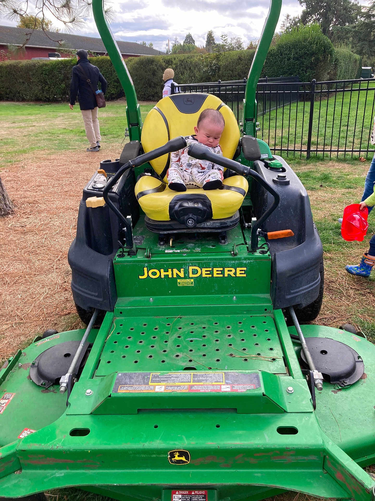 Hunter joined the competition — help win amazing prizes! baby, child, john_deere, lawn_mower, yellow_seat, green_machine, outdoor, grass, park, person, fence, tree, cloudy_sky, people, toy, boots, red_bucket, playground, casual_clothing, nature