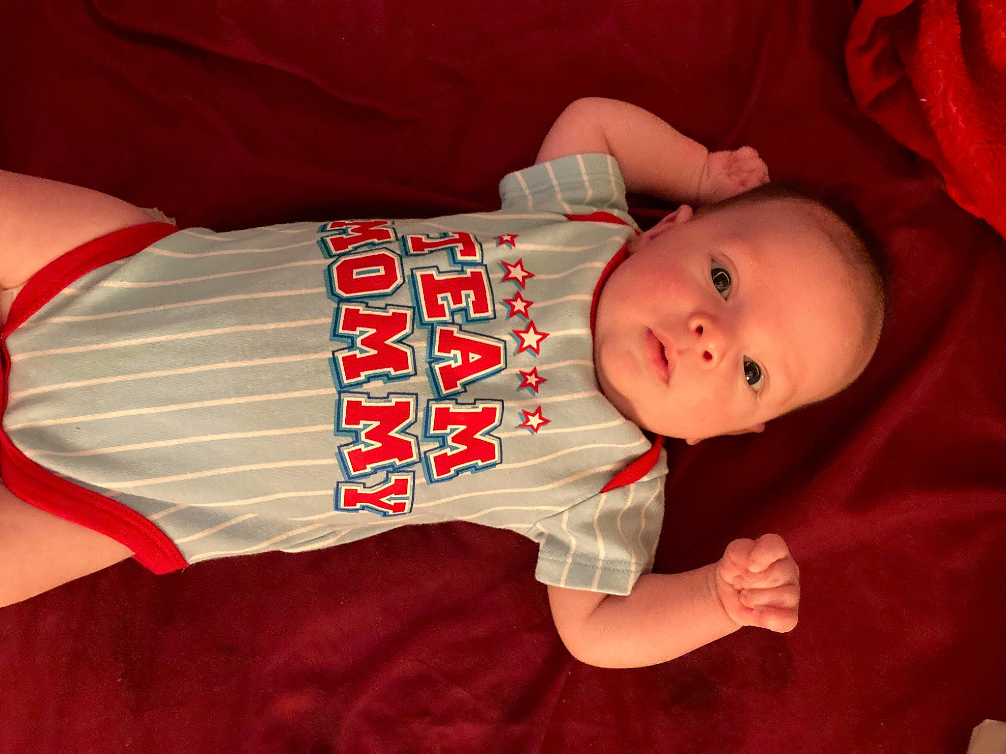 Jasiah is registered to the contest to win money with this photo: arm, baby, baby_products, baby_toddler_clothing, carmine, child, comfort, elbow, finger, hand, hat, human_body, human_leg, lap, orange, person, sitting, skin, sleeve, textile