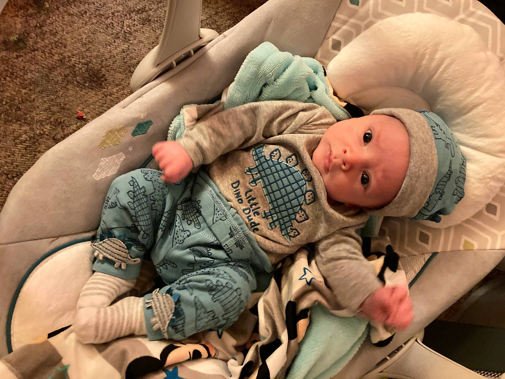 Jasiah is registered to the contest to win money with this photo: arm, baby, baby_carriage, baby_products, baby_sleeping, baby_toddler_clothing, camouflage, child, comfort, glasses, hand, headwear, human_body, human_leg, joint, leg, mouth, person, sitting, skin