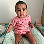 Lyna participe au concours pour gagner de l'argent avec cette photo : baby, bedroom, blanket, child, curious, cushion, cute, decor, earrings, footwear, hair_ponytail, indoors, infant, person, pink_clothing, sandals, sitting, soft_lighting, wide_eyes, wooden_furniture