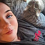 animal, blanket, blue_eyes, casual, cat, closeup, cozy, curious, face, female, gray_cat, indoor, laying_down, person, pet, portrait, resting, soft_texture, tabby_cat, window_light