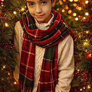 Eduardo joined the competition — help win amazing prizes! background, bokeh, boy, child, christmas, festive, green, happy, holiday, lights, ornaments, pine, portrait, red, scarf, smile, sweater, tree, warm, winter