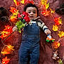 Kayleb joined the competition — help win amazing prizes! autumn_leaves, baby, blanket, child, cozy, cute, decor, denim_overalls, fall_theme, flowers, holiday, indoor, lying_down, pinecones, portrait, red_flowers, socks, string_lights, striped_shirt, toy_gnome