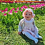 baby, child, tulips, flowers, grass, sun_hat, pink_dress, smiling, outdoor, spring, nature, greenery, garden, sitting, cute, sunny, daylight, happy, person, portrait