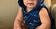 Milan joined the competition — help win amazing prizes! baby, child, infant, hood, blue_clothing, shark_pattern, couch, beige_background, sitting, toes, fingers, cute, chubby_cheeks, wide_eyes, portrait, indoors, soft_lighting, curious, person, comfortable