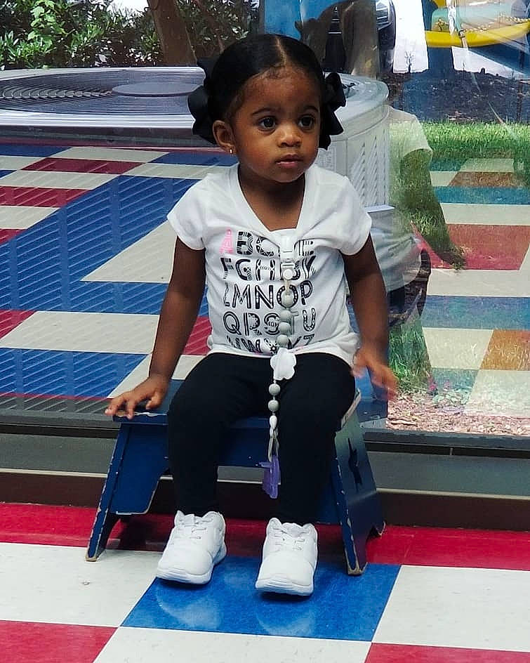 Yasmeen is registered to the contest to win money with this photo: arm, child, day, flooring, footwear, fun, girl, person, play, product, recreation, shoe, shoulder, toddler