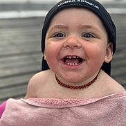 Adem participe au concours pour gagner de l'argent avec cette photo : amber, cap, child, closeup, cute, face, happy, hat, headwear, necklace, outdoor, person, pink, portrait, skin, smiling, teeth, toddler, towel, under_armour