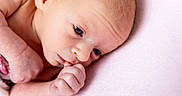 Penelope is registered to the contest to win money with this photo: newborn, baby, infant, portrait, face, eyes, hands, fingers, blanket, pink, soft, closeup, lying_down, curious, awake, skin, hair, head, photography, adorable