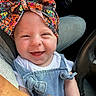 baby, infant, child, smiling, happy, portrait, face, car, car_seat, steering_wheel, overalls, hat, colorful, clothing, indoor, vehicle, close_up, sitting, cheeks, photography