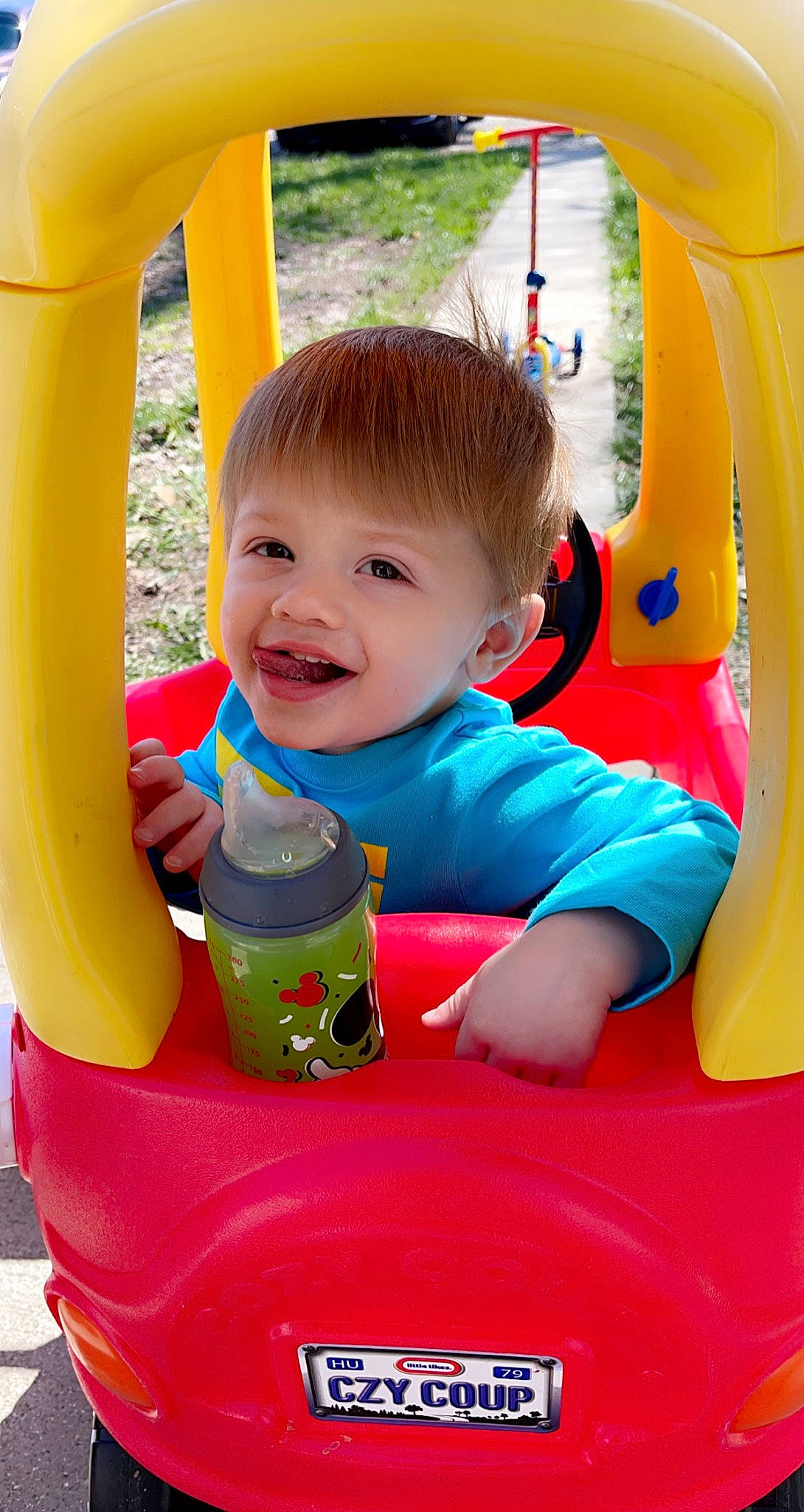 Emmett joined the competition — help win amazing prizes! baby, baby_playing_with_toys, baby_products, baby_toddler_clothing, bottle, child, fun, green, happy, head, human_body, leisure, person, photograph, plastic_bottle, red, riding_toy, skin, smile, toddler