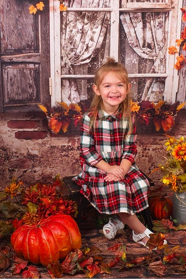 Jewell is registered to the contest to win money with this photo: calabaza, cucurbita, door, gourd, grass, happy, joy, leaf, natural_foods, orange, pattern, people_in_nature, person, photograph, plaid, plant, pumpkin, smile, squash, tartan