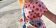 Mika joined the competition — help win amazing prizes! child, blonde_hair, pink_shirt, strawberry_pattern, striped_leggings, small_bag, stitch_character, outdoor, sunlight, sidewalk, street, trees, houses, blue_sky, smiling, person, standing, casual_clothing, daytime, accessory