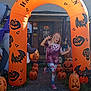 Mika joined the competition — help win amazing prizes! child, halloween, pumpkin, inflatable, archway, costume, skeleton, door, house, decoration, outdoor, holiday, festive, playful, pose, bat, jackolantern, grass, sidewalk, smile
