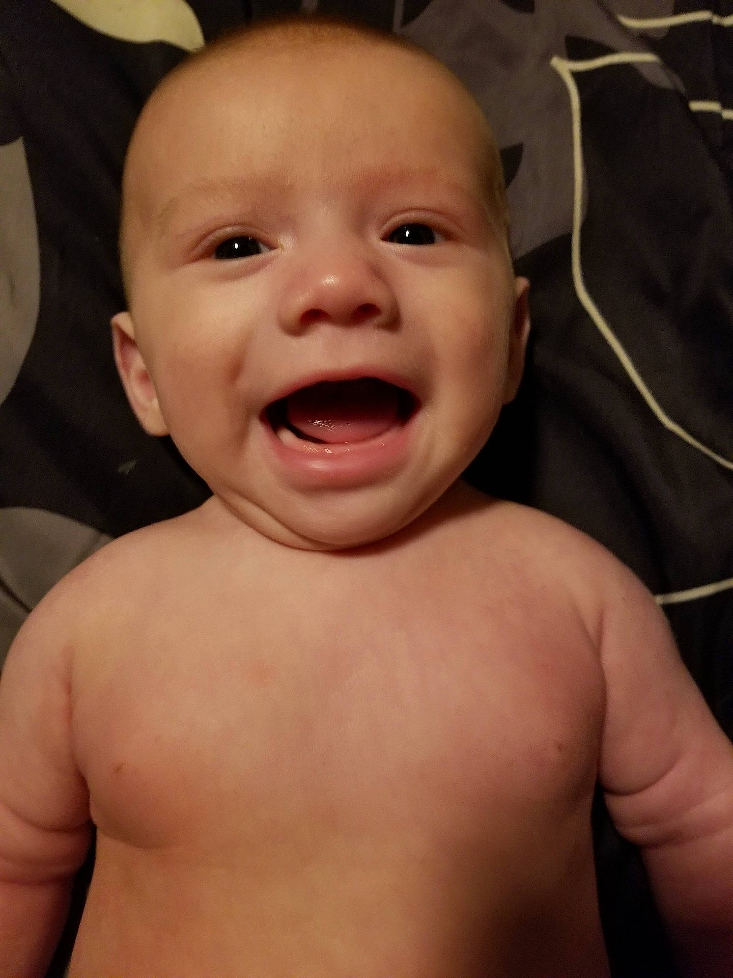 Jose is registered to the contest to win money with this photo: barechestedness, boy, cheek, child, chin, face, facial_expression, finger, forehead, hand, head, infant, laughter, lip, mouth, neck, nose, person, skin, smile