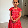 Aadvi joined the competition — help win amazing prizes! child, girl, red_dress, standing, indoor, floor, door, wall, carpet, calm, portrait, person, hands, young, casual, expression, home, light, hair, fashion