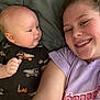 baby, child, woman, smile, selfie, blanket, onesie, pattern, dump_truck, curious, face, skin, head, person, clothing, indoor, casual, happy, closeup, family