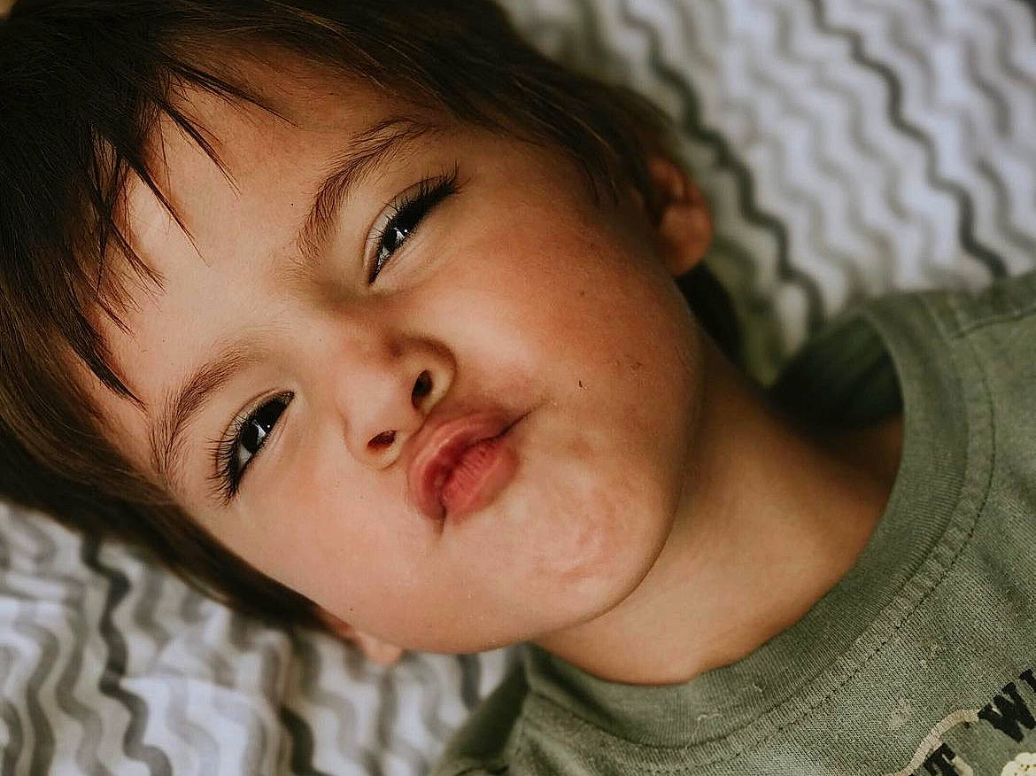 Wyatt is registered to the contest to win money with this photo: black_hair, brown_hair, cheek, child, comfort, ear, eye, eyebrow, eyelash, flash_photography, forehead, gesture, happy, iris, jaw, lip, mouth, nose, person, skin