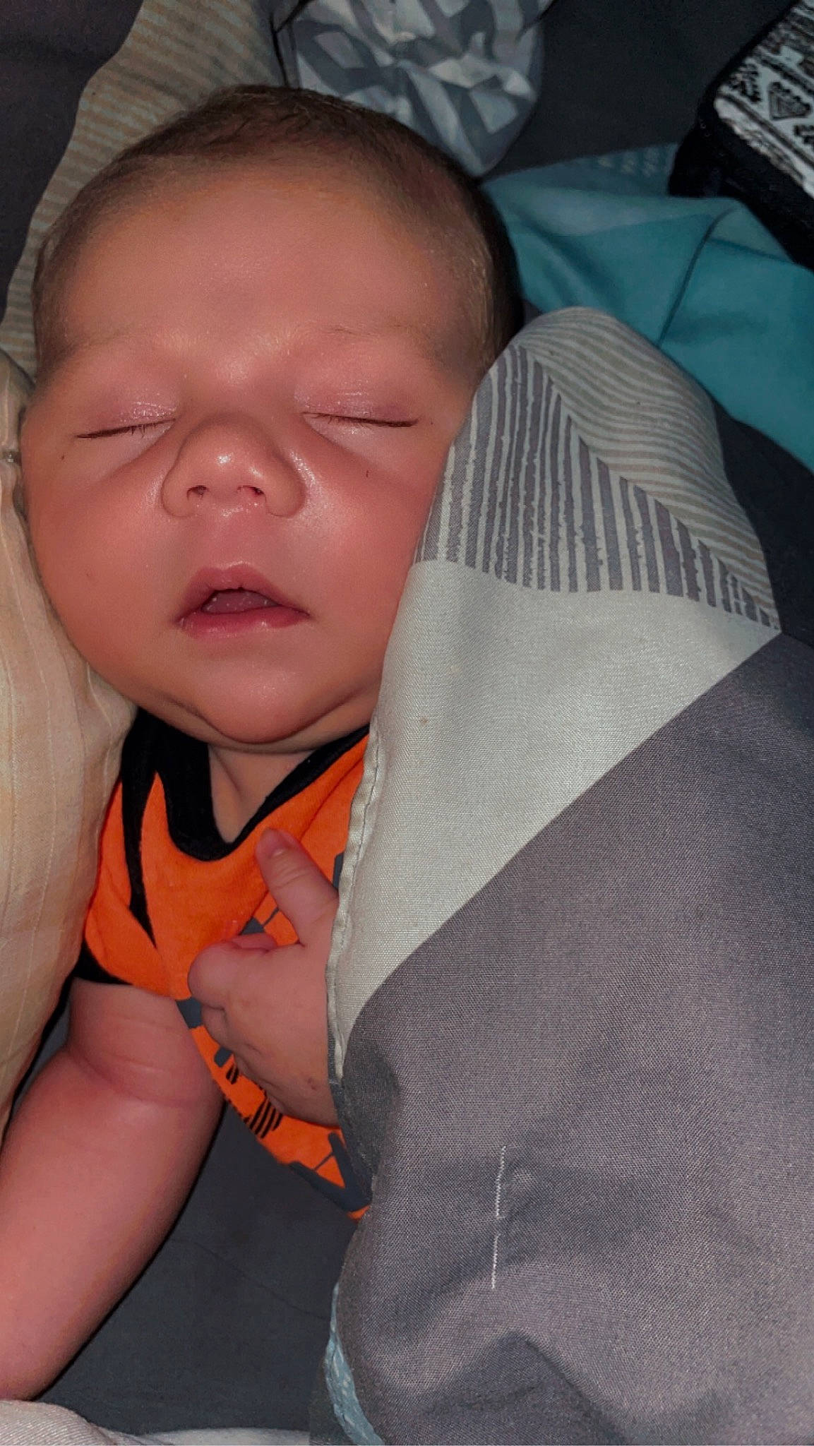 Logan is registered to the contest to win money with this photo: baby, baby_products, baby_toddler_clothing, cheek, child, comfort, eyebrow, eyelash, gesture, happy, linens, mouth, nail, nose, person, skin, sleeve, textile, thumb, toddler