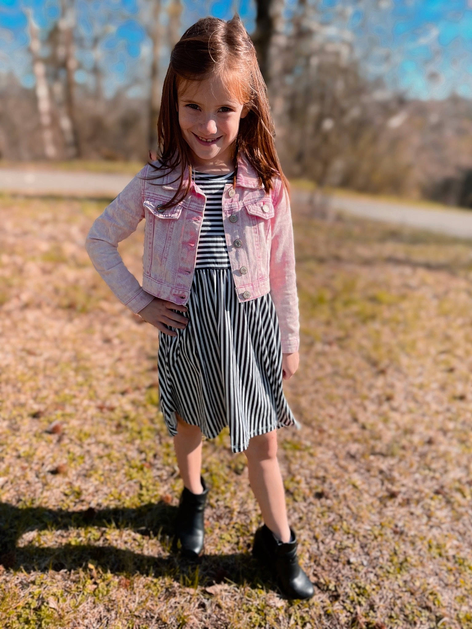 Caelee is registered to the contest to win money with this photo: dress, face, fawn, footwear, grass, hair, happy, human_leg, joy, knee, pattern, people_in_nature, person, plaid, plant, shoe, sleeve, tartan, toddler, tree