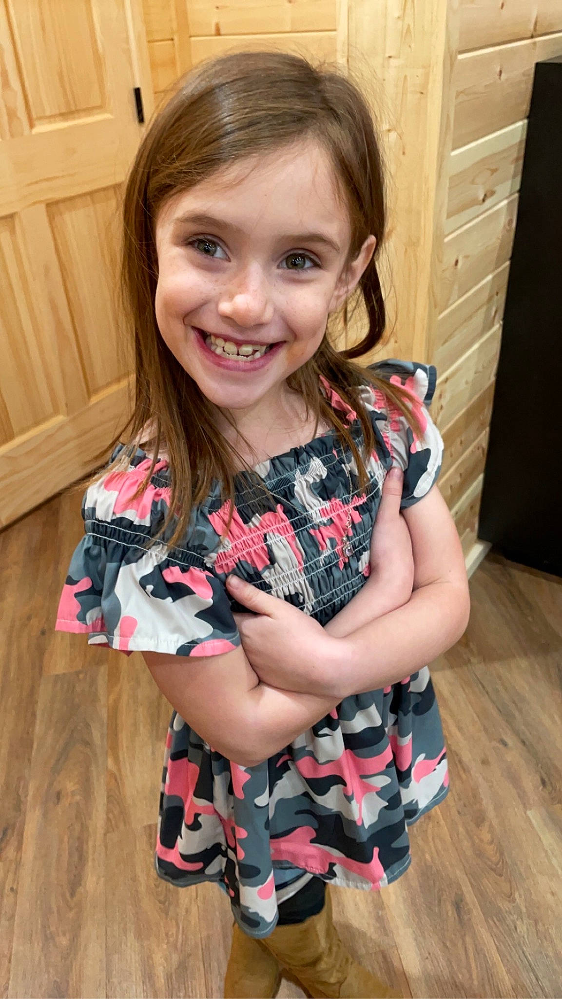 Caelee is registered to the contest to win money with this photo: arm, baby_toddler_clothing, cabinetry, child, eye, face, floor, flooring, hair, happy, hardwood, head, iris, joy, long_hair, person, sleeve, smile, t_shirt, thigh