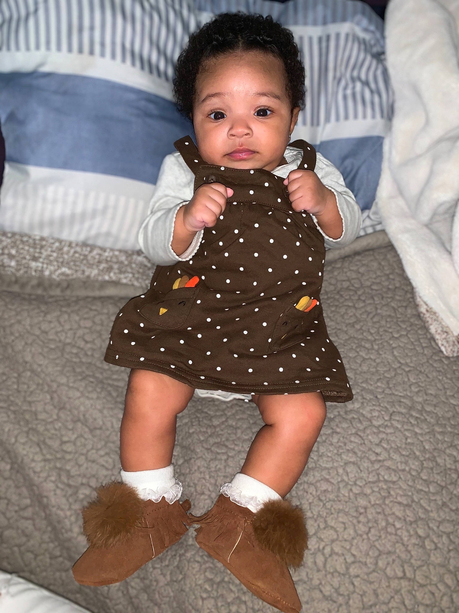 Avani joined the competition — help win amazing prizes! baby, baby_toddler_clothing, boot, child, couch, day_dress, dress, embellishment, linens, living_room, one_piece_garment, pattern, person, pillow, polka_dot, sock, textile, throw_pillow, toddler