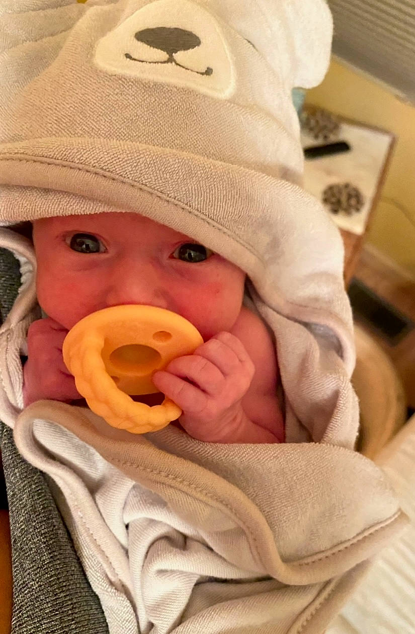 Nora joined the competition — help win amazing prizes! baby, baby_products, baby_toddler_clothing, cap, cheek, comfort, finger, hand, hat, head, headgear, headwear, human_body, lip, mouth, nose, outerwear, person, skin, sleeve