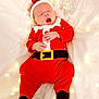 Tommy is registered to the contest to win money with this photo: baby, infant, santa_outfit, christmas, holiday, costume, sleeping, yawning, blanket, fairy_lights, decoration, festive, cute, indoors, holiday_season, red_clothing, white_background, newborn, person, holiday_cheer