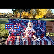 Tyler is registered to the contest to win money with this photo: americanflag, baby, backyard, bench, face, field, flag, furniture, grass, head, lawn, nature, outdoors, park, person, photography, plant, portrait, summer, yard