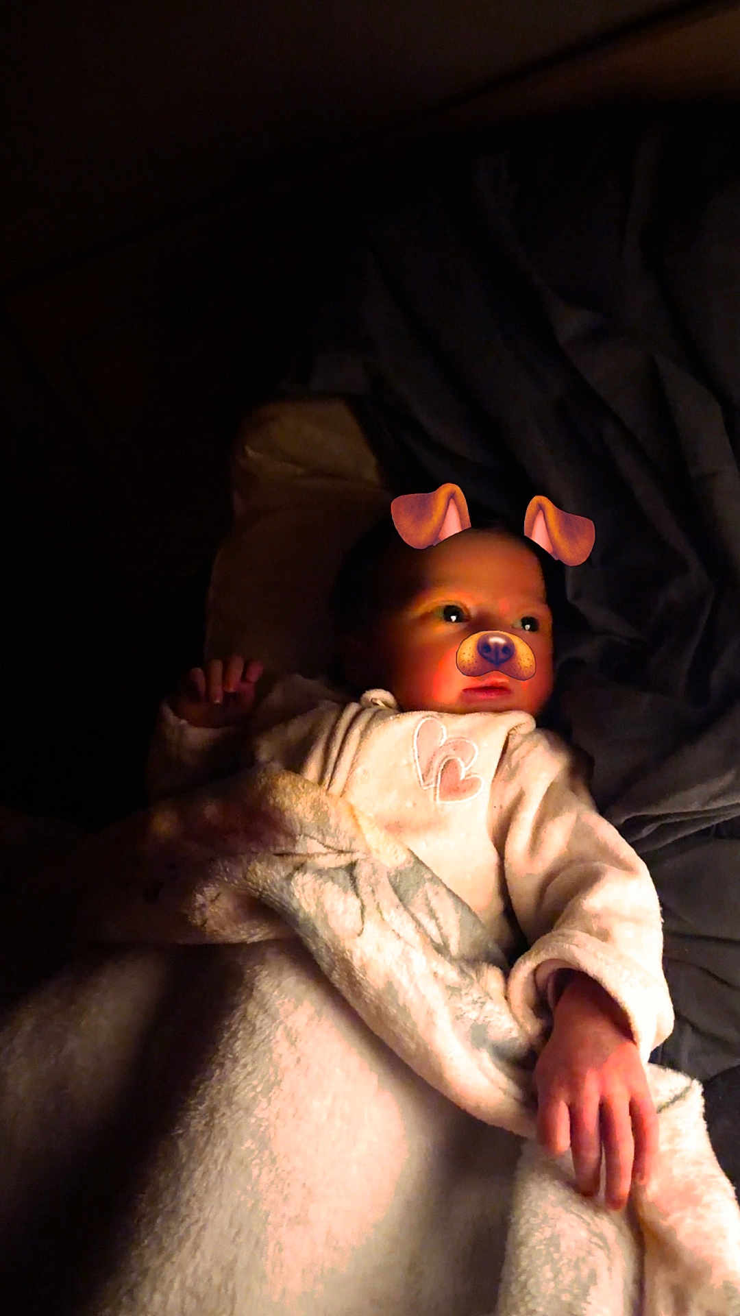 Maddy a rejoint le concours — aidez-le/la à gagner de superbes lots ! baby, infant, child, blanket, dog_filter, face, portrait, hand, pillow, onesie, bed, cozy, night, low_light, cute, lying_down, soft_texture, warm_light, sleepy, filter