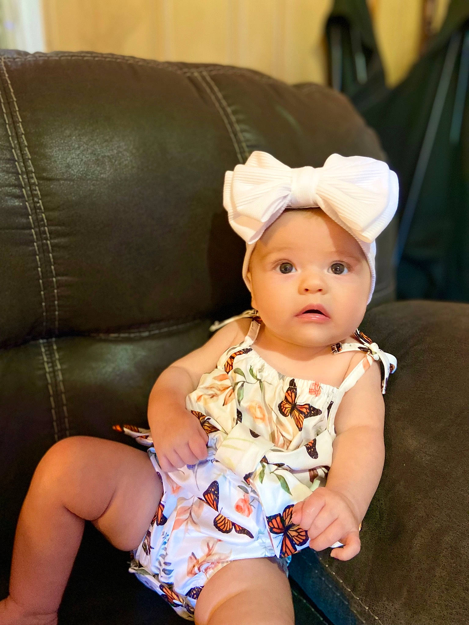Jourdyn is registered to the contest to win money with this photo: baby, baby_toddler_clothing, cheek, child, comfort, couch, fashion_accessory, flash_photography, headband, headgear, headwear, human_leg, pattern, person, photo_shoot, portrait_photography, sandal, sitting, skin, textile