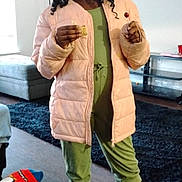 Unyque joined the competition — help win amazing prizes! child, girl, indoor, jacket, pink, green_clothing, boots, lollipop, snack, smiling, standing, hair, curly_hair, floor, rug, sofa, lamp, furniture, home, cozy